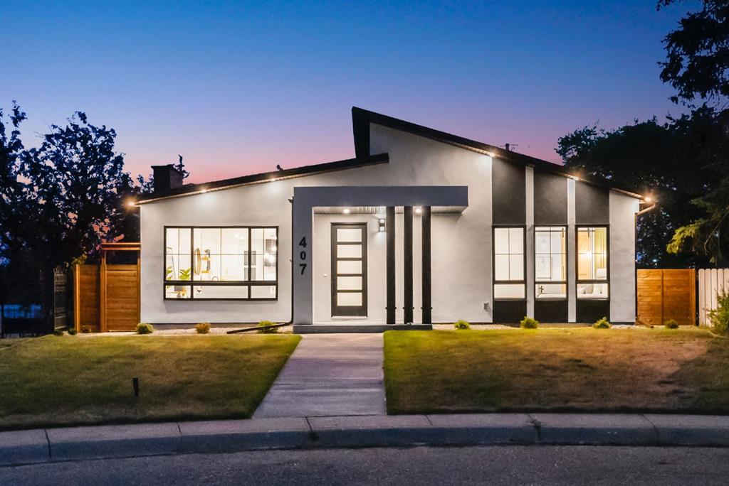 Newly built Calgary infill home with a white stucco exterior photographed at dusk